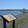 A plaque with information about Salem Harbor and a background featuring a lighthouse and an ocean